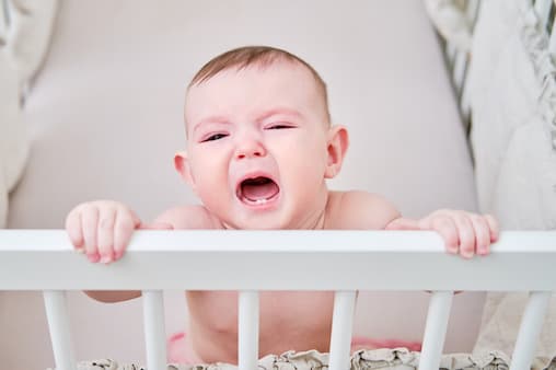 Baby bangs head outlet on crib while sleeping